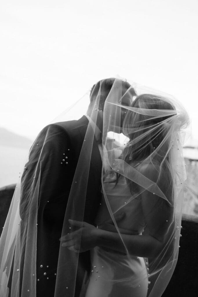 Bride and groom under the veil during couples portraits at Villa Antiche Mura